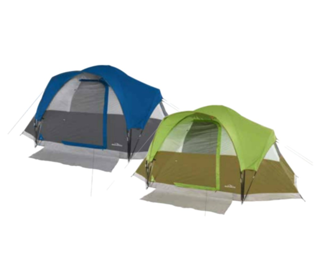 Adventuridge camping gear laid out on a natural outdoor setting with tents pitched and trekking poles leaning against a tree