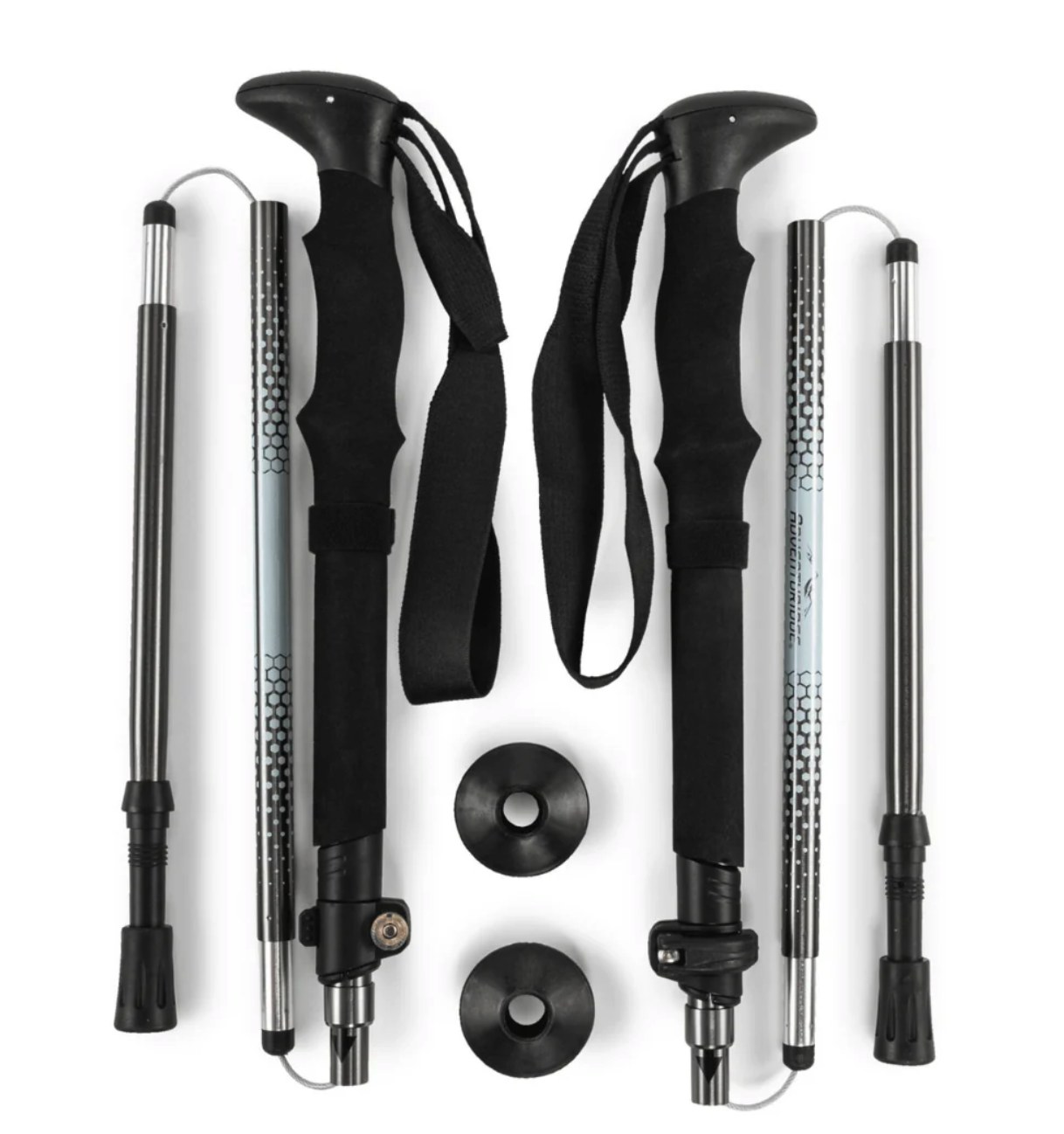 A pair of Adventuridge folding trekking poles laid flat, showing T-grip handles, wrist straps, segmented silver shafts with honeycomb pattern, and two rubber baskets